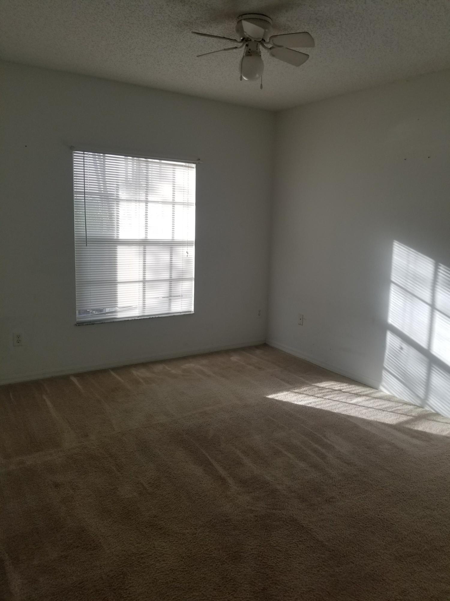 5064 Lantana Road, Unit 6107 Lake Worth, FL 33463 - Photo 10 of 26 an empty room with a empty space and windows