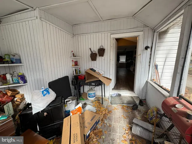 a living room with furniture a rug and a window