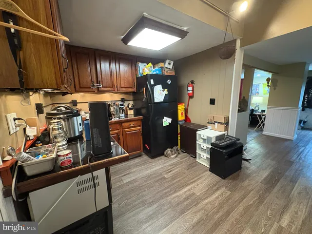 a room with lots of wooden furniture and windows