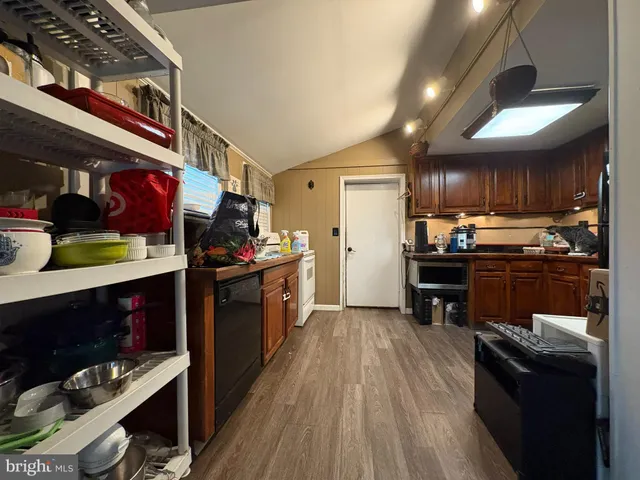 a kitchen with stainless steel appliances kitchen island granite countertop a stove a sink and a refrigerator