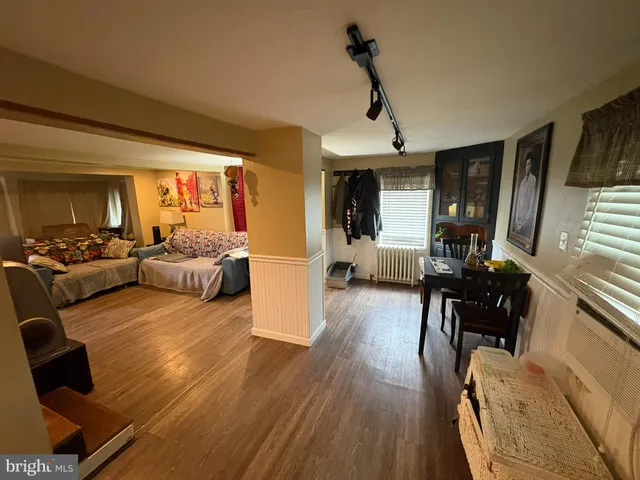 a living room with furniture or couch and a wooden floor