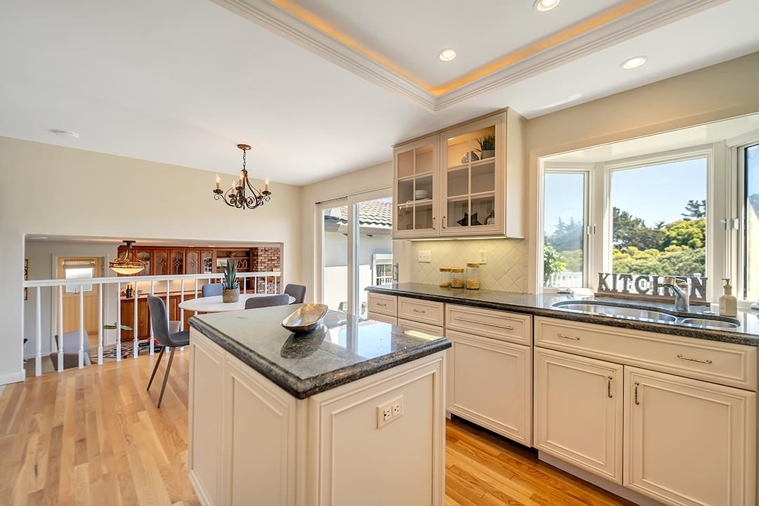 1049 Springfield Drive Millbrae, CA 94030 - Photo 14 of 51 a open kitchen with stainless steel appliances granite countertop a lot of counter space and wooden floors