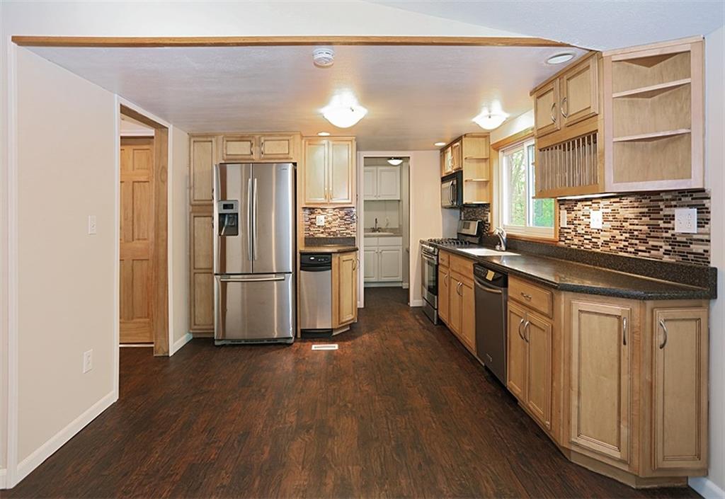 595 Hall Road Beaver, PA 15009 - Photo 3 of 17 Great kitchen with SS appliances. You can see how convenient the laundry room is and it has a pocket door.