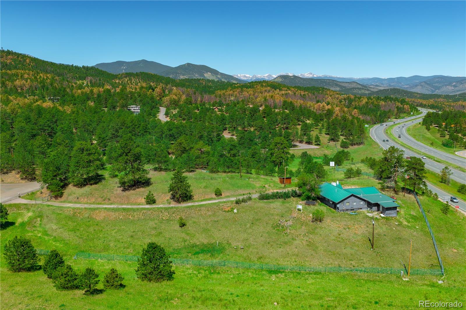 29793 Ruby Ranch Road Evergreen, CO 80439 - Photo 24 of 28 a view of a lush green hillside and houses