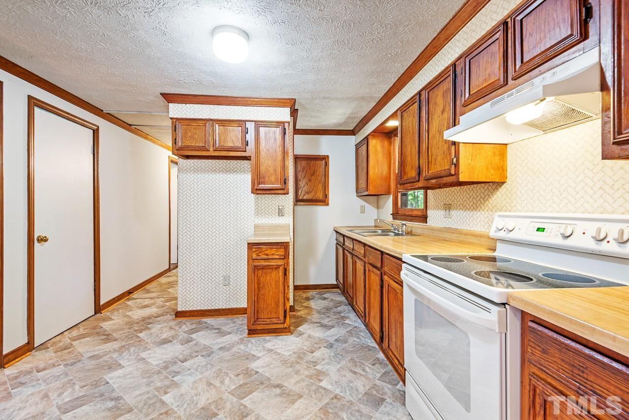 3014 Dearborn Drive Durham, NC 27704 - Photo 11 of 30 a kitchen with stainless steel appliances granite countertop a refrigerator and a stove top oven