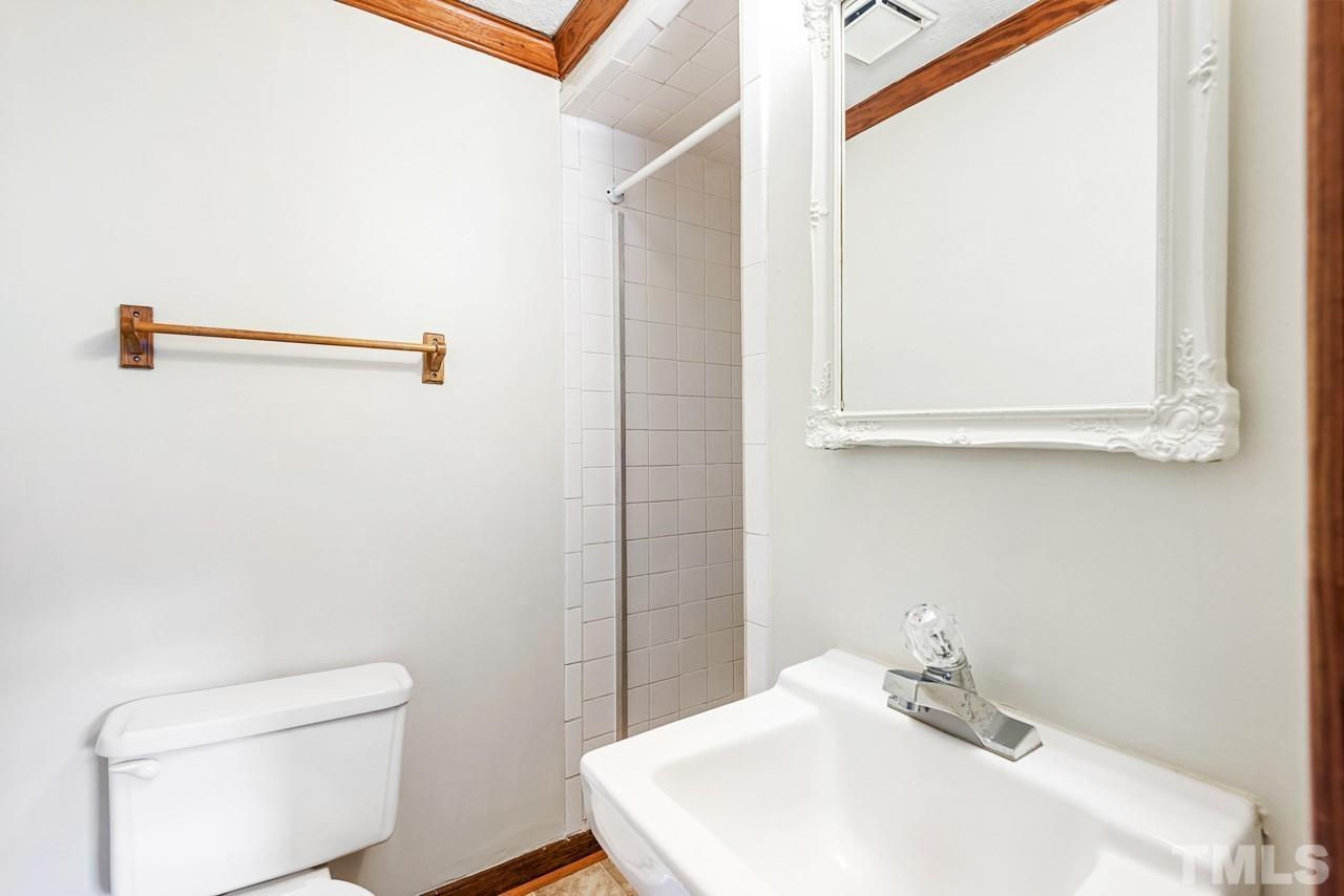 3014 Dearborn Drive Durham, NC 27704 - Photo 20 of 30 a bathroom with a sink a toilet and mirror