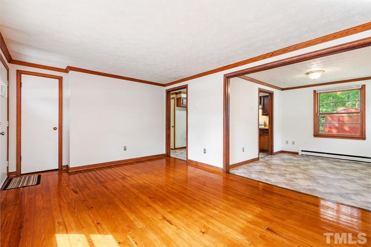 3014 Dearborn Drive Durham, NC 27704 - Photo 22 of 30 a view of an empty room with window and wooden floor