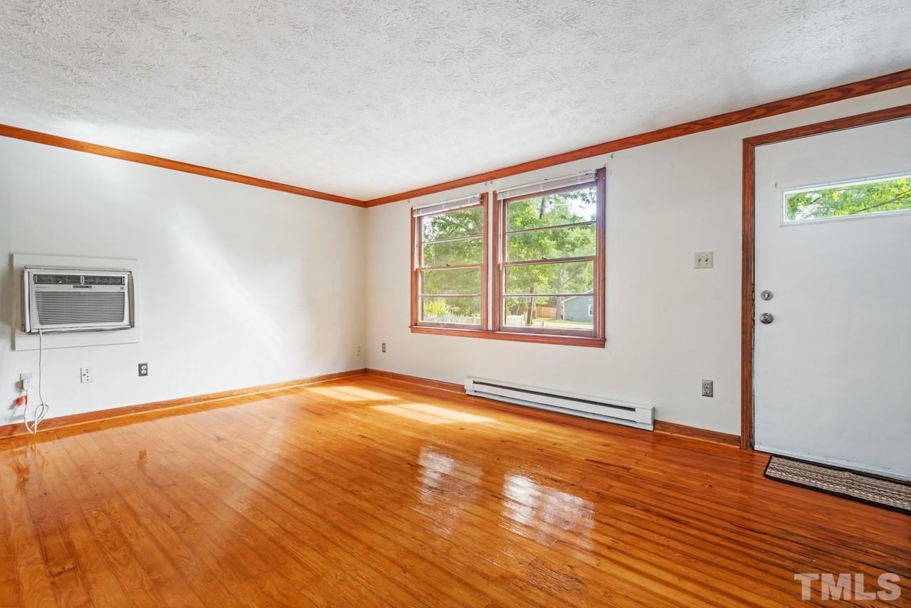 3014 Dearborn Drive Durham, NC 27704 - Photo 23 of 30 a view of an empty room with wooden floor and a window