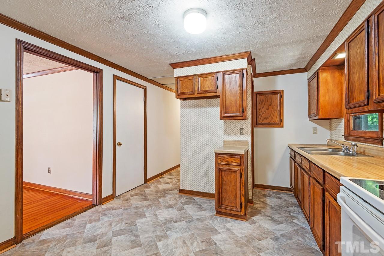 3014 Dearborn Drive Durham, NC 27704 - Photo 24 of 30 a view of a kitchen with stainless steel appliances granite countertop cabinets and a window