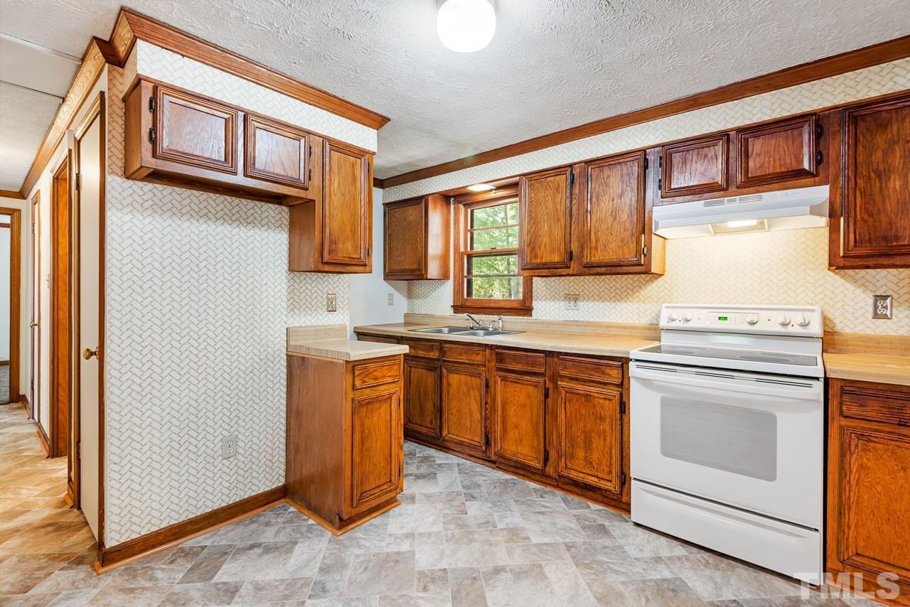 3014 Dearborn Drive Durham, NC 27704 - Photo 4 of 30 a kitchen with stainless steel appliances granite countertop a refrigerator and a stove top oven
