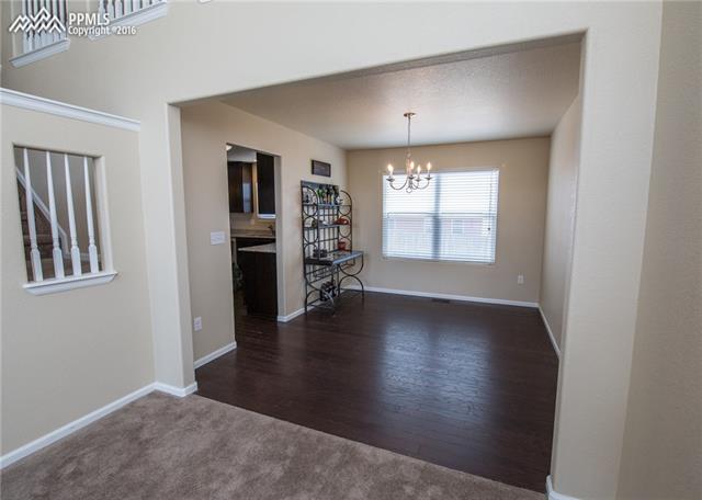 7945 Morning Dew Road Colorado Springs, CO 80908 - Photo 6 of 32 Formal dining area that leads to the kitchen.