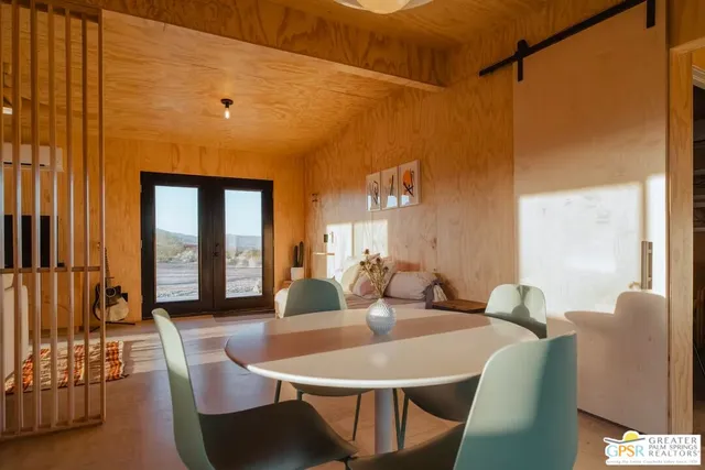 a view of a dining room with furniture and window