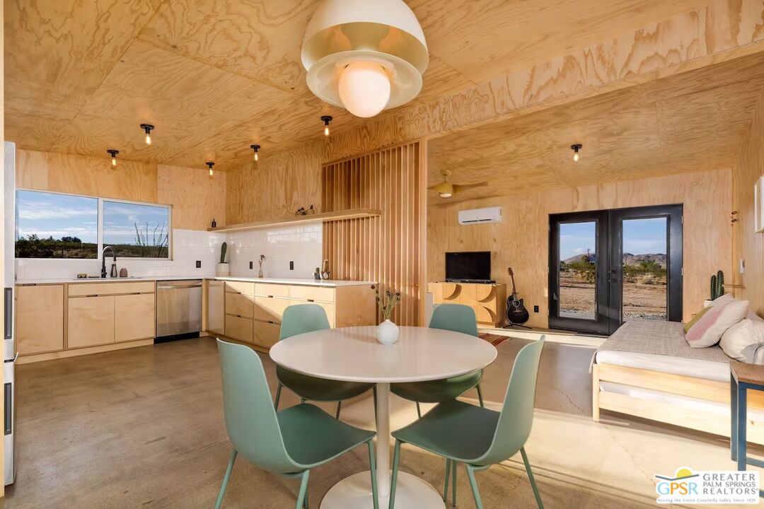 4619 Kickapoo Trail Landers, CA 92285 - Photo 18 of 55 a kitchen with a table chairs sink and cabinets