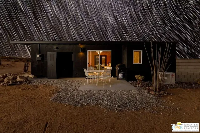 a front view of a house with sitting area