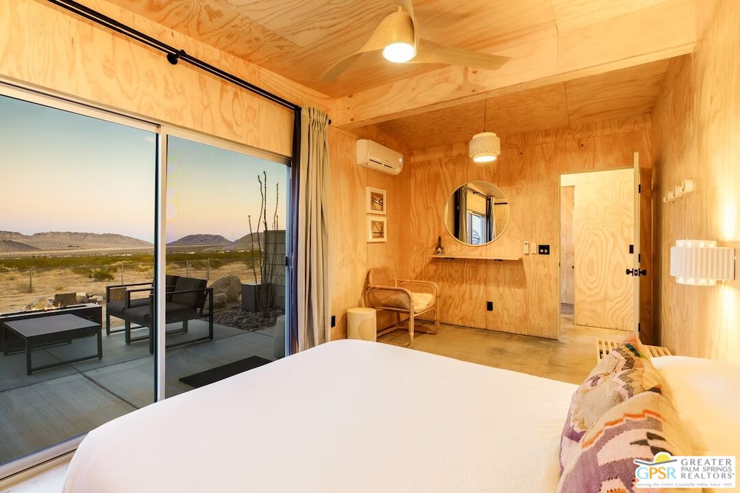 4619 Kickapoo Trail Landers, CA 92285 - Photo 33 of 55 a bedroom with a bed and large windows