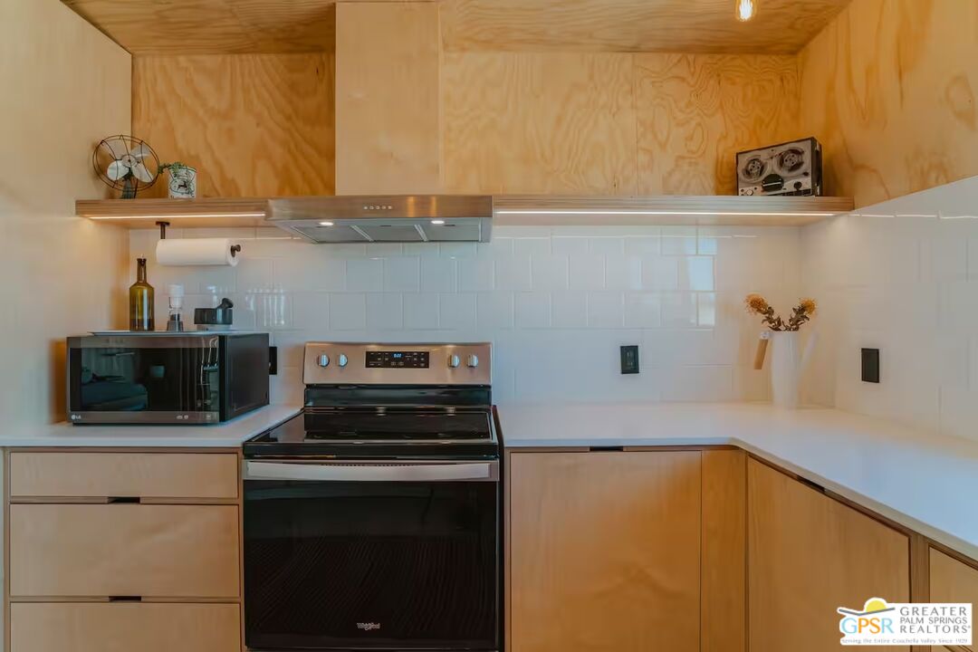 4619 Kickapoo Trail Landers, CA 92285 - Photo 36 of 55 a kitchen with a stove and a microwave