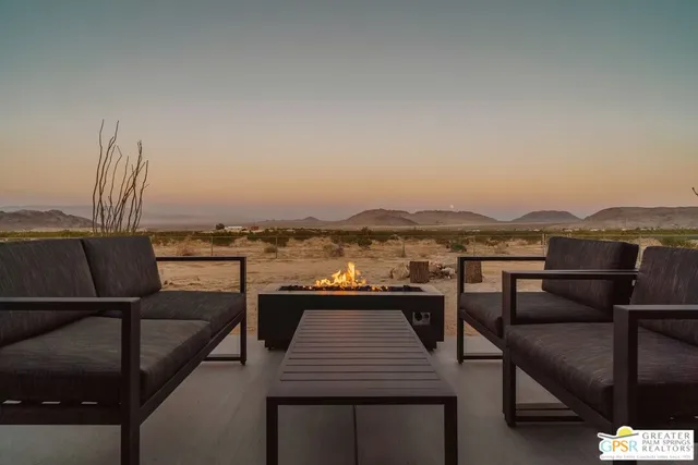 a view of a terrace with furniture and a floor to ceiling window