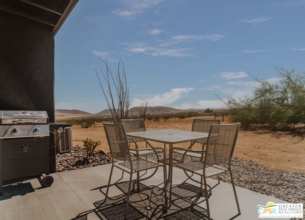 4619 Kickapoo Trail Landers, CA 92285 - Photo 10 of 55 a view of a terrace with furniture and a floor to ceiling window
