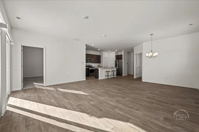 a view of a kitchen with wooden floor and a sink