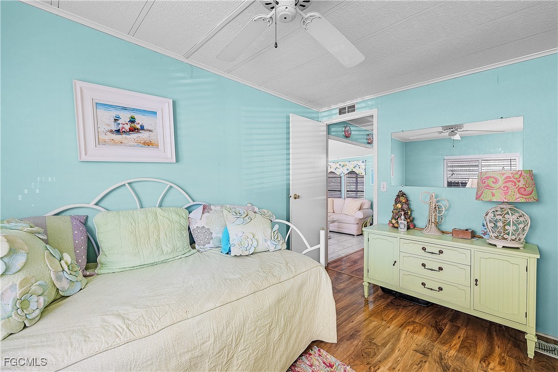 7696 Helen Road Bokeelia, FL 33922 - Photo 20 of 45 a bedroom with a bed and wooden floor