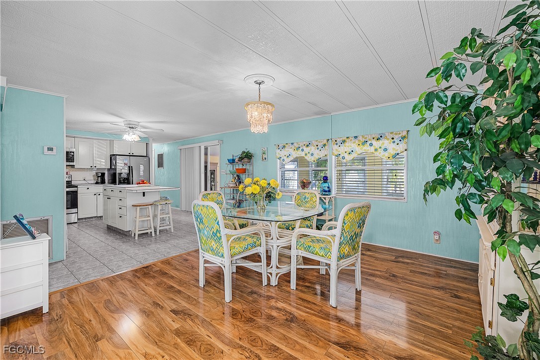 7696 Helen Road Bokeelia, FL 33922 - Photo 22 of 45 a view of a dining room with furniture and wooden floor
