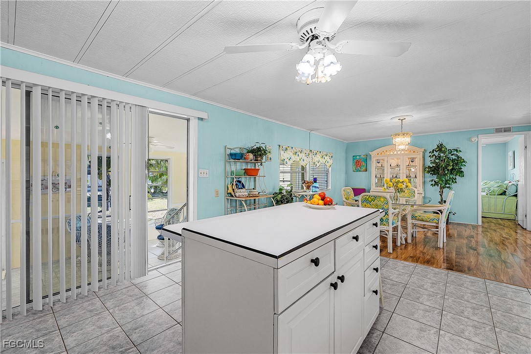 7696 Helen Road Bokeelia, FL 33922 - Photo 24 of 45 a kitchen that has a table and chairs in it