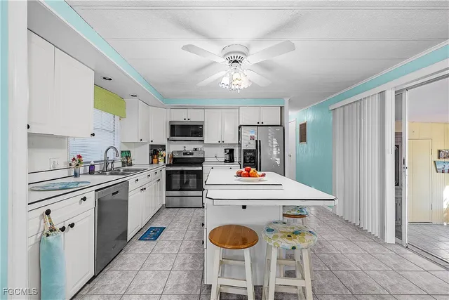 a kitchen with cabinets a sink and stainless steel appliances