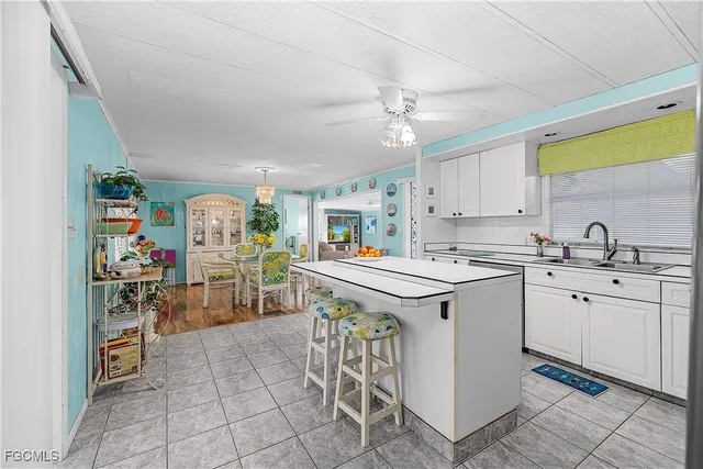 a kitchen with a sink a stove cabinets and counter space