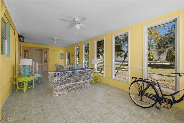 a view of a livingroom with furniture staircase and a large window