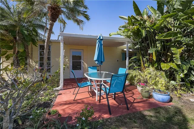 a view of a chairs and table in the patio