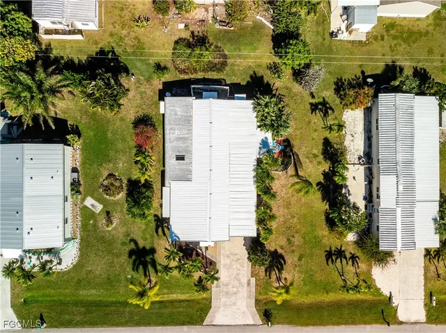 an aerial view of a residential apartment building with a yard