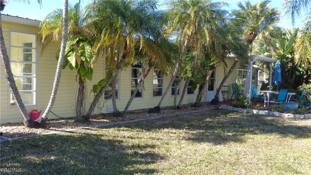 7696 Helen Road Bokeelia, FL 33922 - Photo 5 of 45 a view of a backyard with large tree