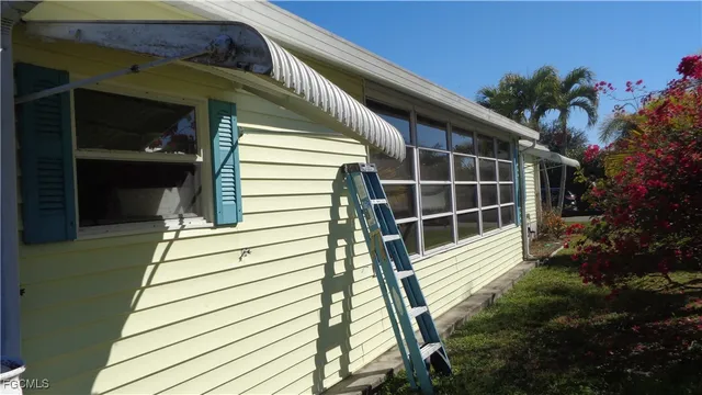 a view of balcony with wooden floor and potted plants