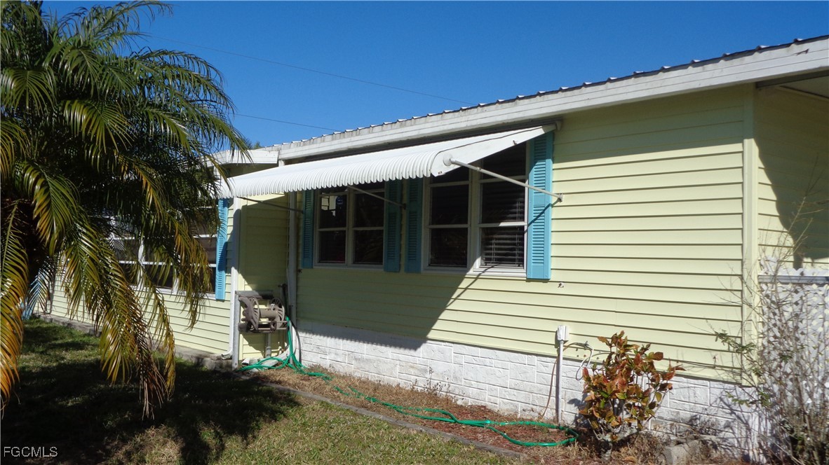 7696 Helen Road Bokeelia, FL 33922 - Photo 9 of 45 a front view of a house with a yard