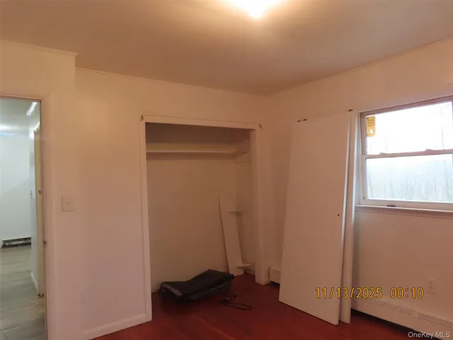 a room with a window and wooden floor