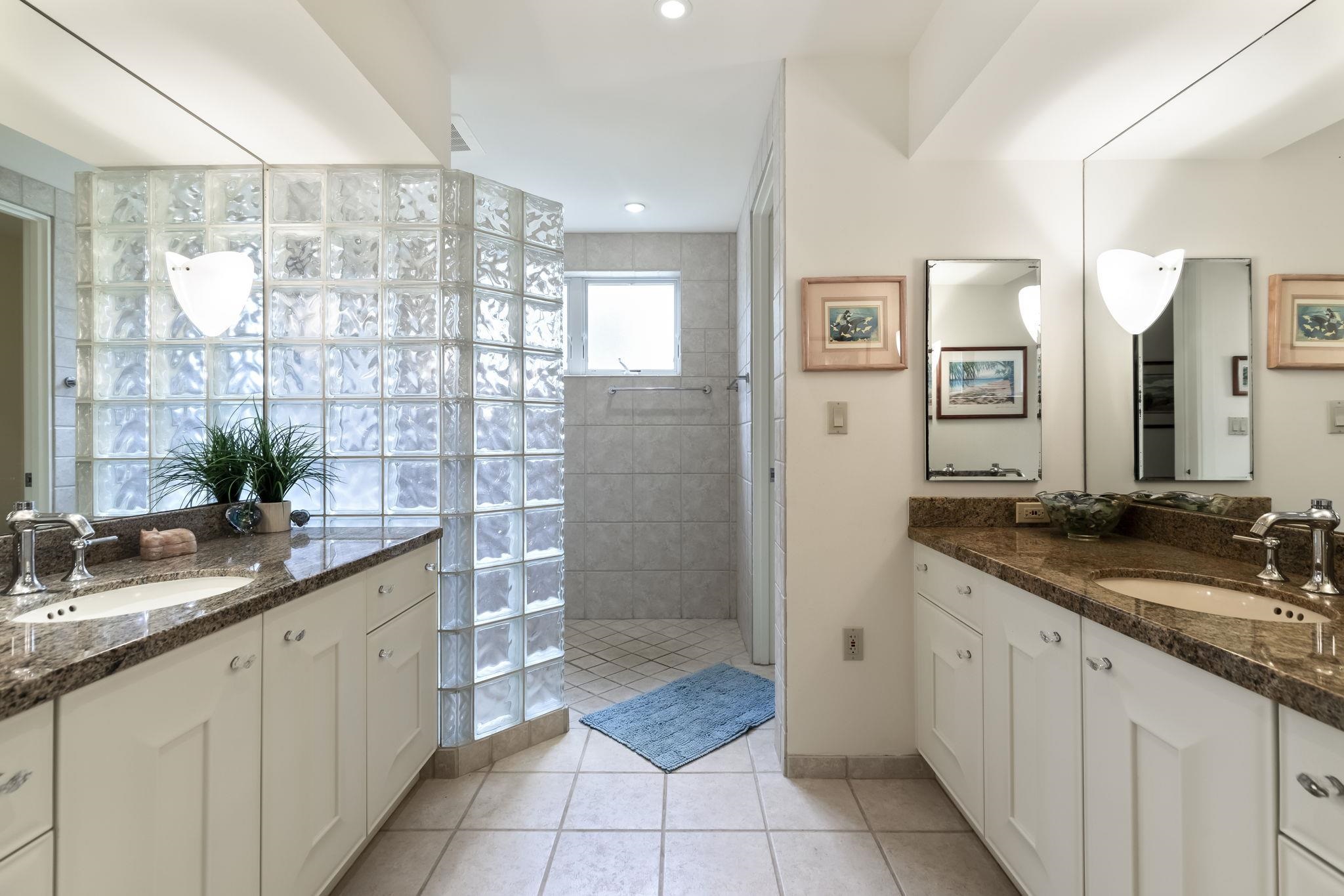 4955 Makena Road, Unit C302 Kihei, HI 96753 - Photo 23 of 37 a spacious bathroom with a granite countertop sink a mirror and a shower