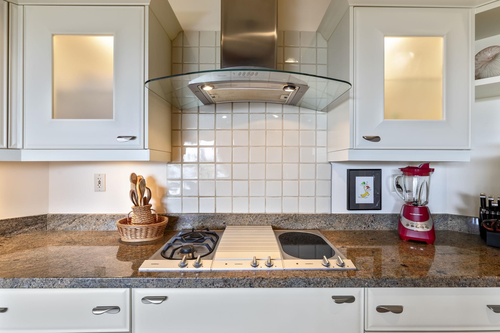 4955 Makena Road, Unit C302 Kihei, HI 96753 - Photo 9 of 37 a kitchen with granite countertop white cabinets and white appliances