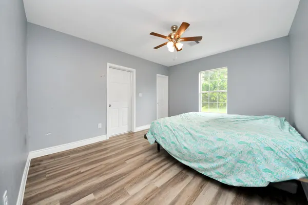 a bedroom with a bed and a window