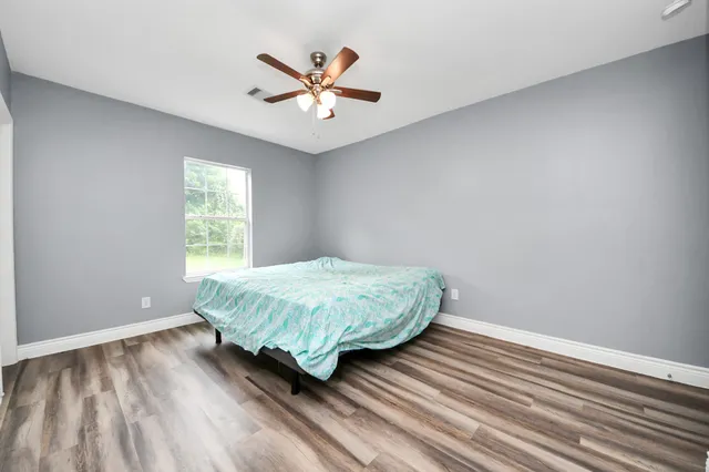 wooden floor in an empty room with a window