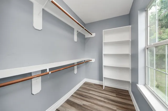 a view of a room with rack on the wall and a window