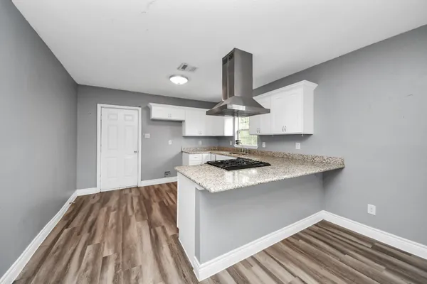 a kitchen with a stove and a sink