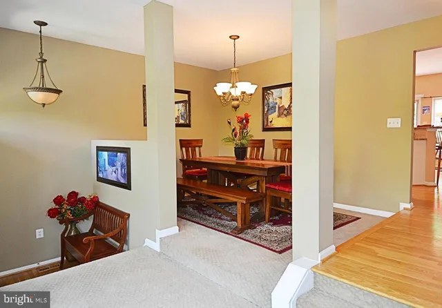 a view of a hallway with front door and wooden floor