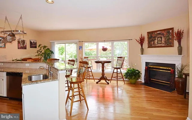 a living room with furniture a fireplace and a floor to ceiling window