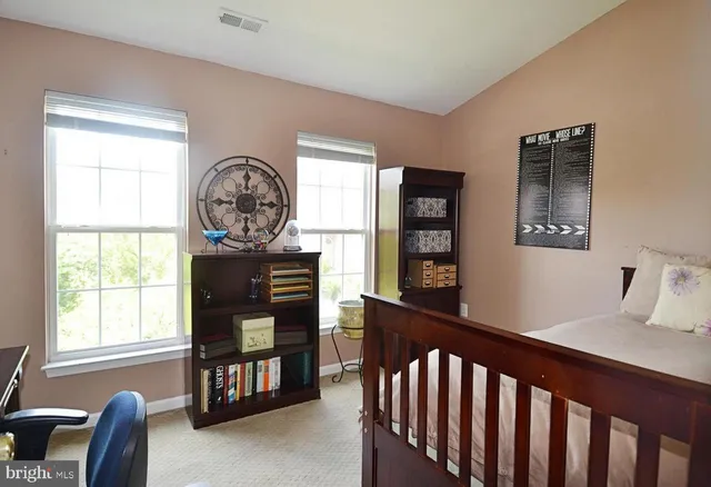 a living room with furniture a flat screen tv and a window