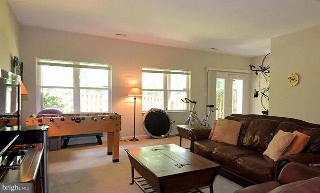 a bedroom with a chair and a window