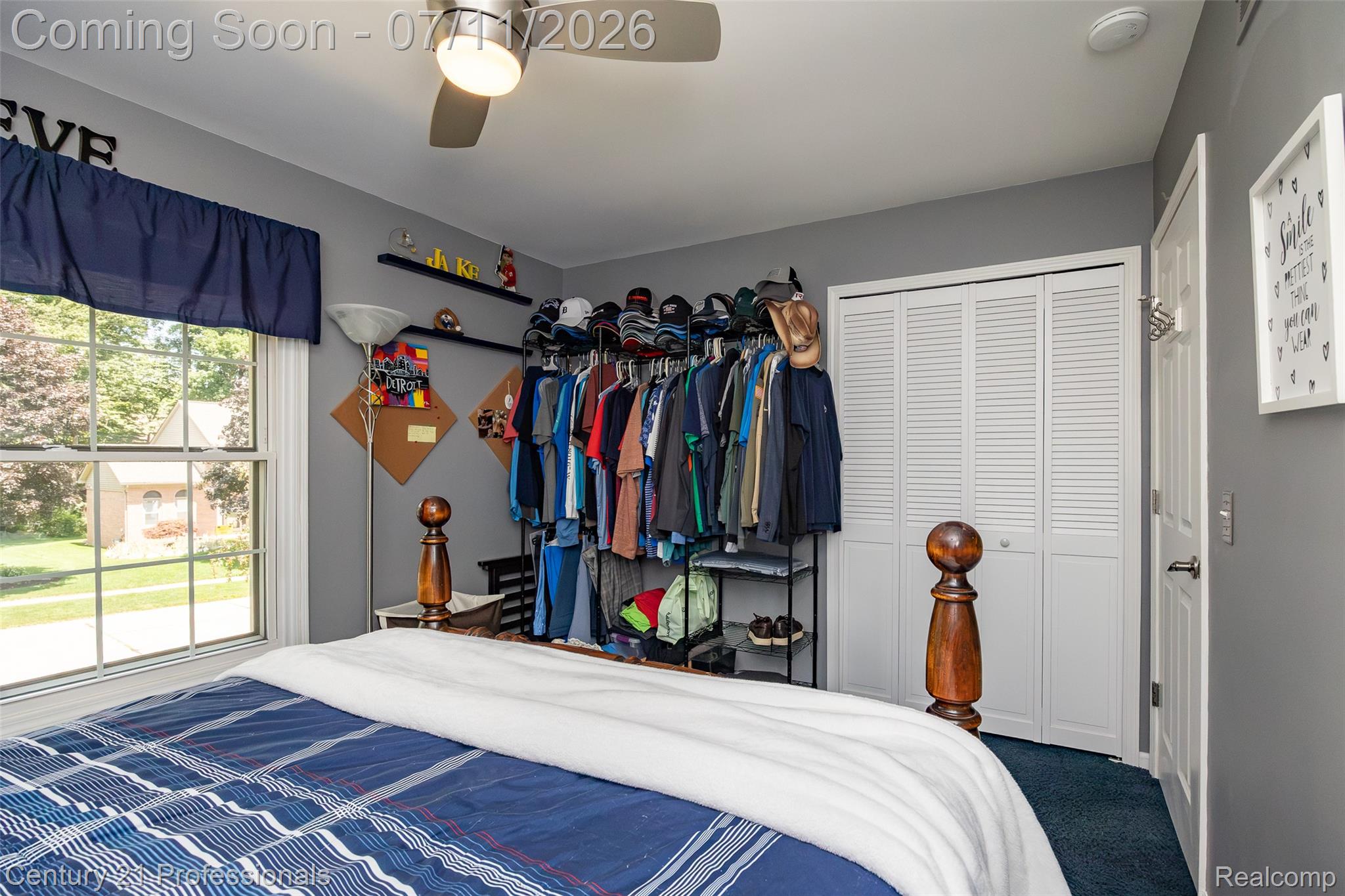 689 Woodfield Way Rochester, MI 48307 - Photo 35 of 61 Bedroom featuring a double-hung window, a ceiling fan with integrated lighting, and bifold louvered closet doors