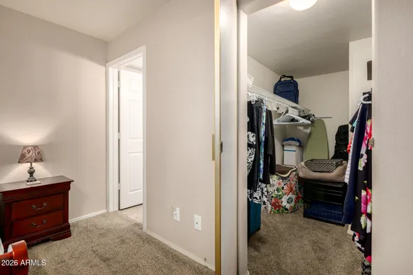a view of walk in closet with clothes and shoes