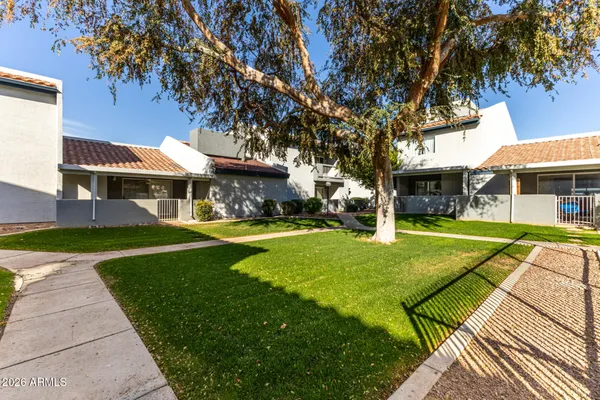 a backyard of a house with table and chairs