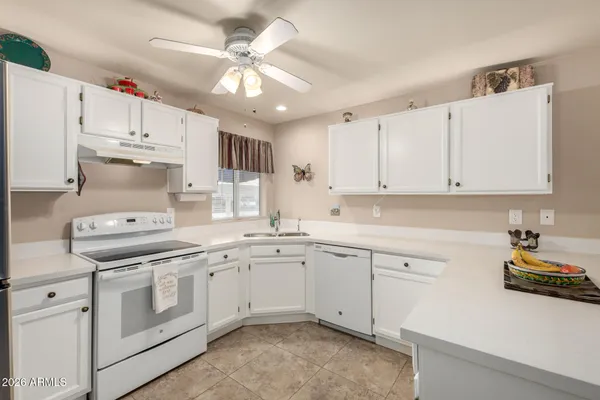 a kitchen with cabinets appliances a sink and a counter top space