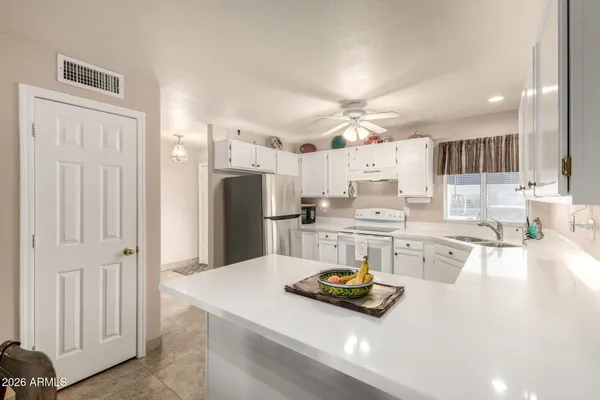 a kitchen with refrigerator and cabinets